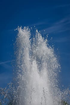 Water splash in fountain on blue sky background