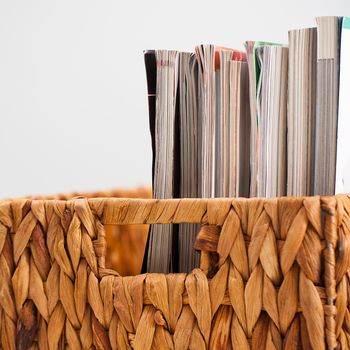 Closeup image of magazines in a straw pleated box