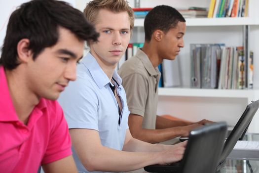 Three university students working on assignment