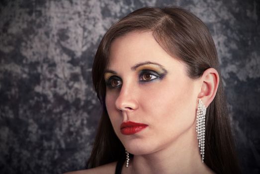 Portrait of a beautiful brunette with luxury earrings.