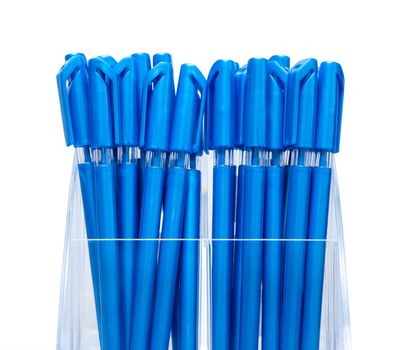 Set of pens in a plastic stand on an isolated background.