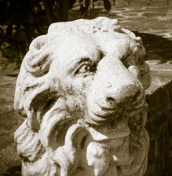 Black and white lion head made of stone