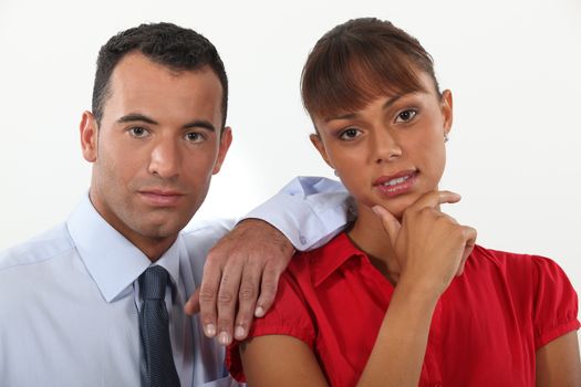 young businessman and businesswoman posing together