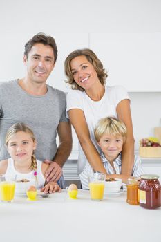 Smiling family at breakfast in the kitchen