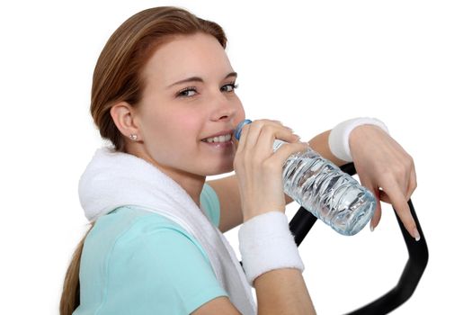 Woman drinking water during a workout