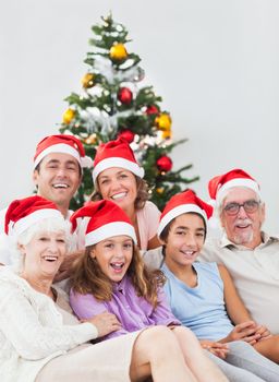 Happy family sitting on couch at christmas