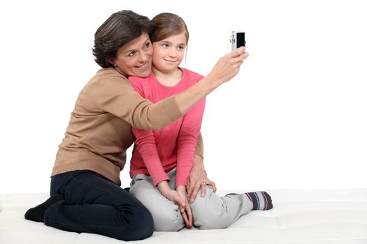 Woman taking a picture of herself with her granddaughter