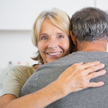 Cute couple embracing in the kitchen