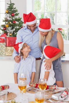 Happy family at christmas by the dinner table