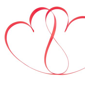 Pink ribbon in heart shapes on white background