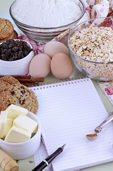 Fresh ingredients for oatmeal cookies with pen and paper. Shallow depth of field. 