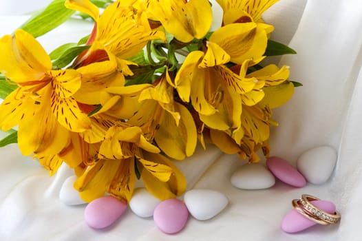 Wedding favors,wedding rings and flowers on white background