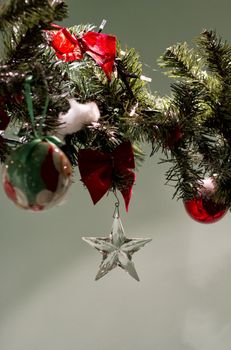 A glass star pending from a christmas decoration