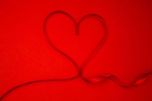 Ribbon shaped into a heart in red