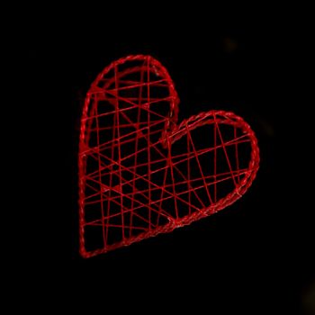 Red heart shaped box on black background