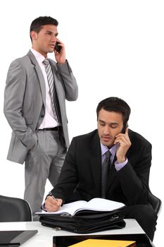 Two businessmen working towards deadline