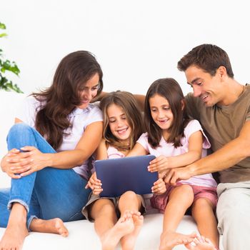 Pretty family using a digital tablet on a sofa