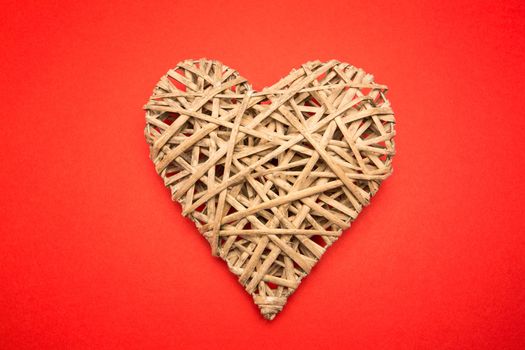 Wicker heart on red background