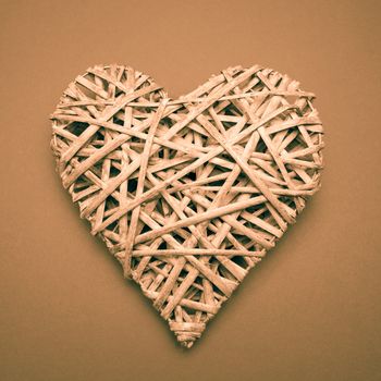 Wicker heart ornament on brown background