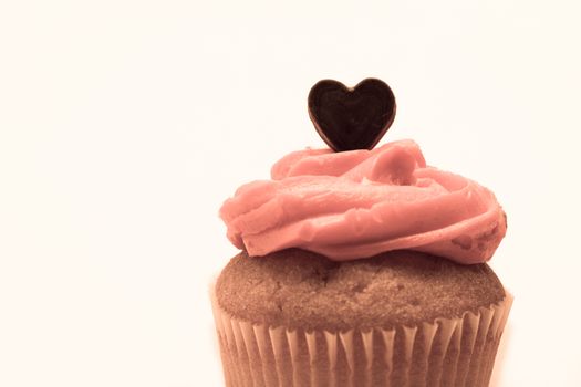 Valentines cupcake with pink icing and chocolate heart