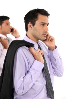 Two young businessmen holding jackets over shoulders