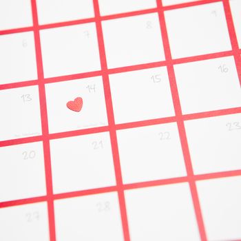 Confetti heart on valentines day on pink and white calendar