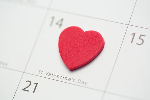 Close up of pink heart on valentines day on white calendar