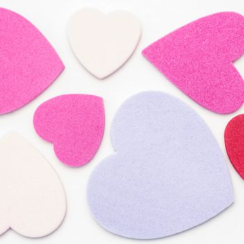 Various confetti hearts on white background