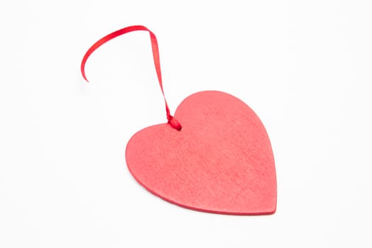 Heart ornament with ribbon on white background