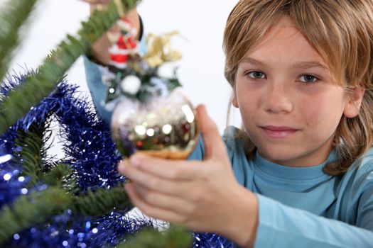 Kid decorating Christmas tree