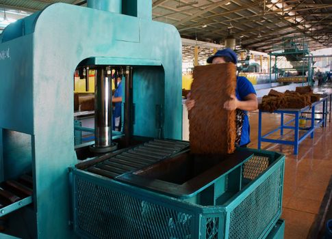 in Viet Nam, there are many rubber plantation, rubber latex after collected, transport to factory.Right here, prelimitary treatment processing in ten stage, this is the tenth to pressure in package. Binh Phuoc, Viet Nam- May 09, 2013