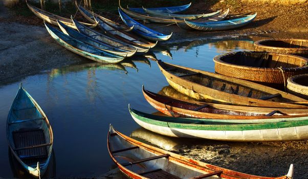 in early moring, this place concentrate many small craft of  fisherman who live with fishery, small bamboo craft with multicolor under golden light at sunrise make beautiful scene