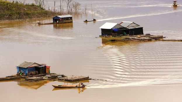  the scene of fisherman coming their lake dwelling by motor-boat at fishing village create ripplings on the water suface is so lively. This fishing village locate at NamKa lake, Dalak.