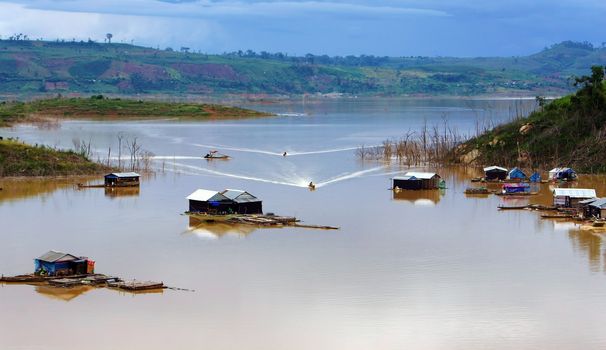  the scene of fisherman coming their lake dwelling by motor-boat at fishing village create ripplings on the water suface is so lively. This fishing village locate at NamKa lake, Dalak.