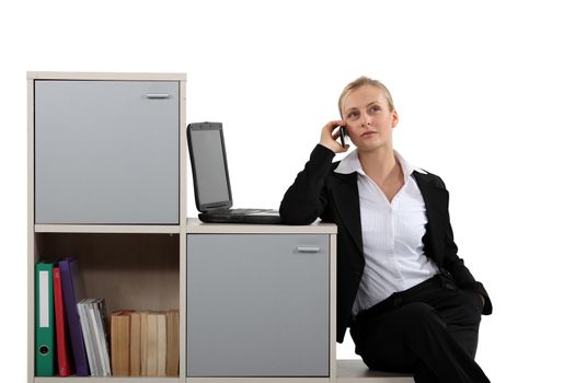 businesswoman working at home on the phone near laptop