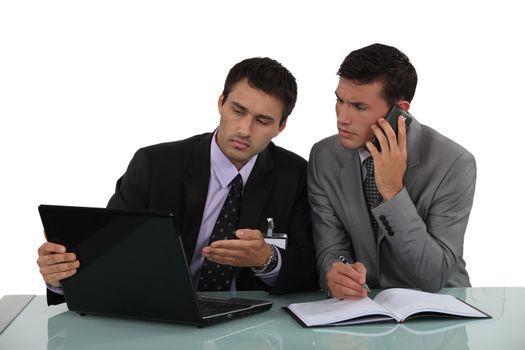 Businessman working out a problem on a laptop