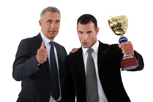 Businessmen with a trophy