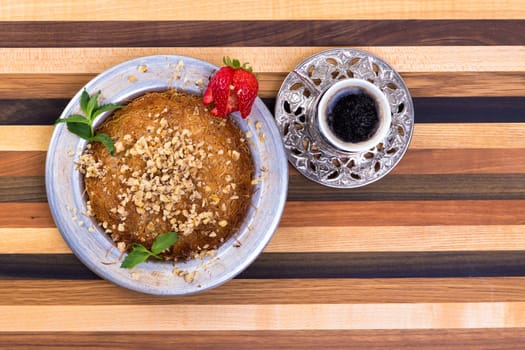 Turkish Dessert Kunefe on a multicolor wooden cutting board with Turkish Coffee