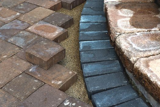 Paving around patio steps with diffrent color tumbled pavers