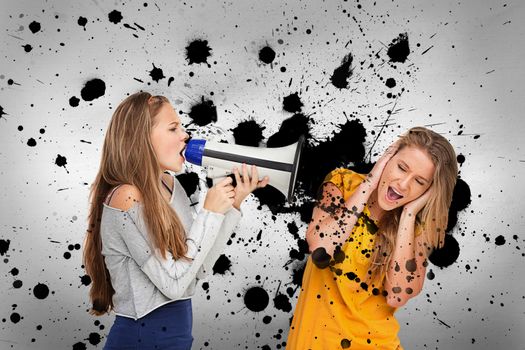 Girl shouting at friend through megaphone on ink splashed background