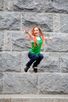 jumping young girl near the wall