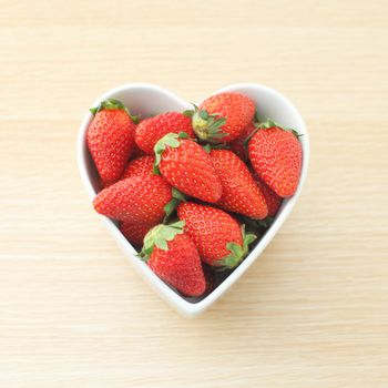 Strawberry in heart shape bowl