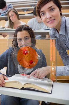 Student and teacher looking futuristic interface during lecture