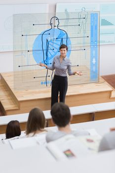 Standing teacher in front of futuristic interface asking a question to students