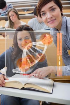 Teacher and student looking futuristic interface with DNA on it