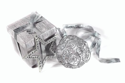 Silver christmas gift with decoration isolated on white background