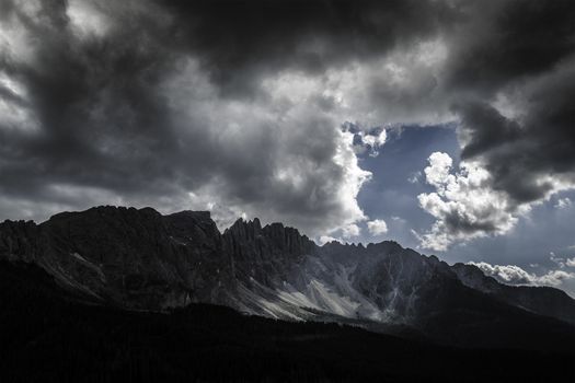 Ray of light on Latemar and storm clouds, Dolomiti