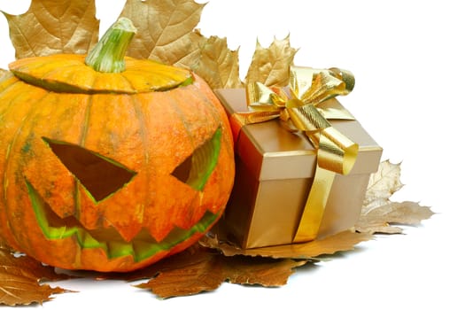 Halloween pumpkin with autumn leafs and gift isolated on white