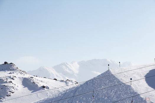 Mountain peaks of winter alps under blue sky