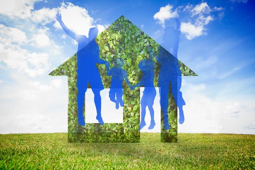 Jumping family and green house against sky background